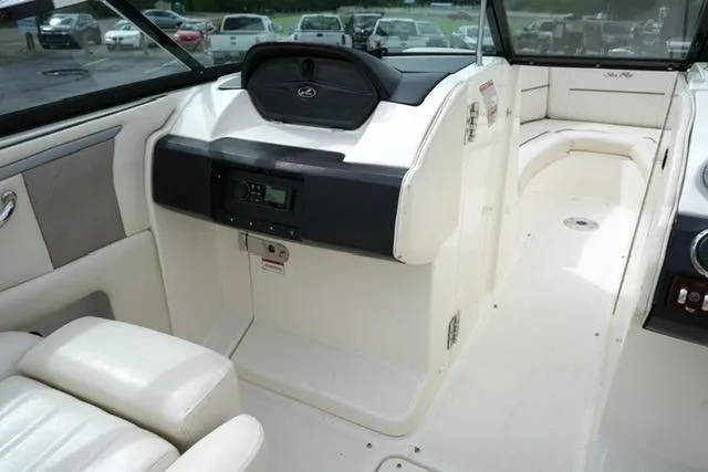 Slide: The Image of Interior view of a 2007 Sea Ray SLX 250 boat, featuring seating and control panel. - 11