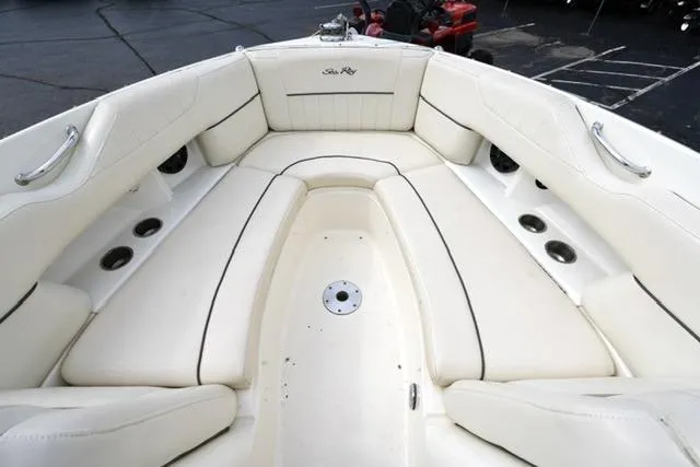 Slide: The Image of 2007 Sea Ray SLX 250 boat interior with white cushioned seating and stainless steel accents. - 13
