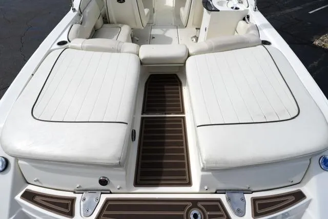 Slide: The Image of 2007 Sea Ray SLX 250 boat interior with white cushioned seating and brown flooring. - 14