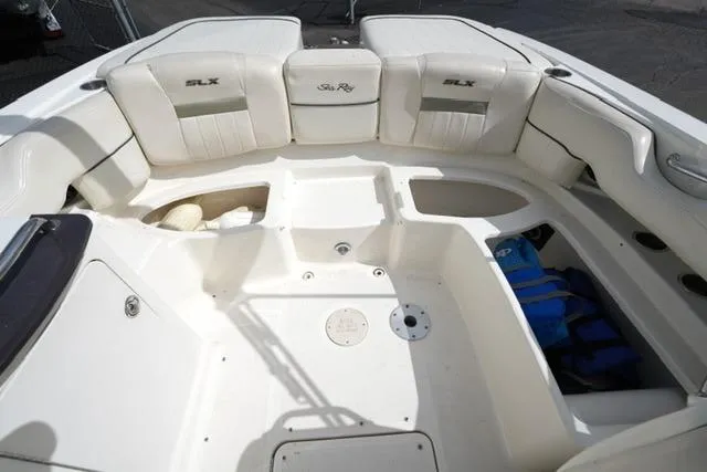 Slide: The Image of 2007 Sea Ray SLX 250 boat interior with white seating and storage compartments. - 15