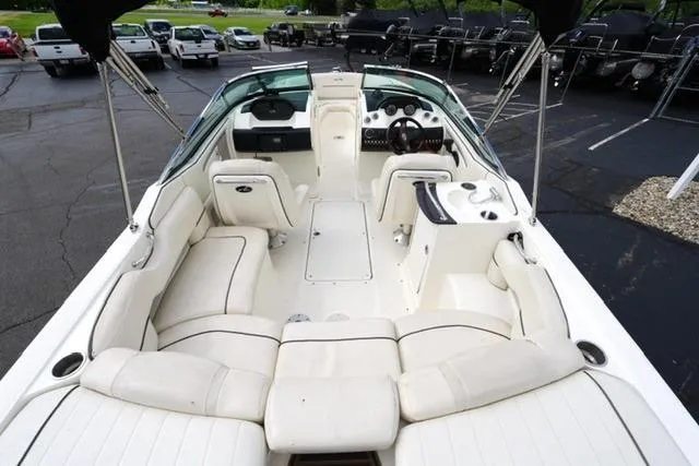 Slide: The Image of 2007 Sea Ray SLX 250 boat interior with white seating and dashboard view. - 16