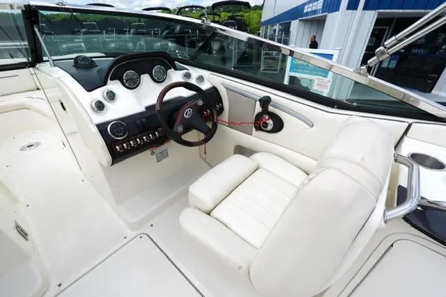 Slide: The Image of 2007 Sea Ray SLX 250 boat interior with white seating and modern dashboard controls. - 17