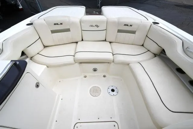 Slide: The Image of 2007 Sea Ray SLX 250 boat interior with white cushioned seating. - 18