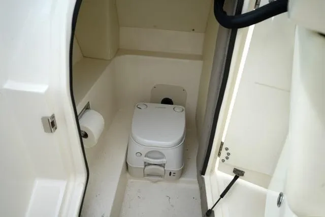 Slide: The Image of 2007 Sea Ray SLX 250 boat interior with compact marine toilet. - 19