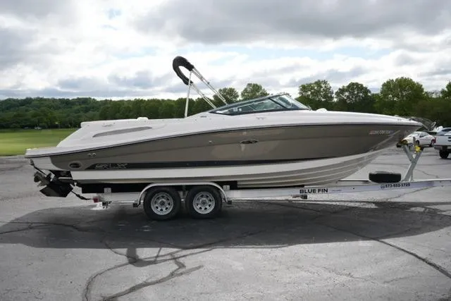 Slide: The Image of 2007 Sea Ray SLX 250 boat on trailer, parked outdoors under cloudy sky. - 4