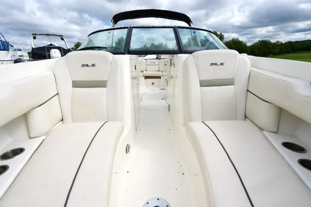 Slide: The Image of 2007 Sea Ray SLX 250 boat interior with white seating and open deck layout. - 9