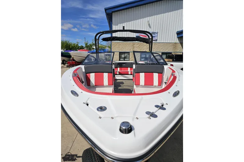 Slide: The Image of 2020 Glastron GTS 225 boat with red and white interior, docked outdoors. - 18