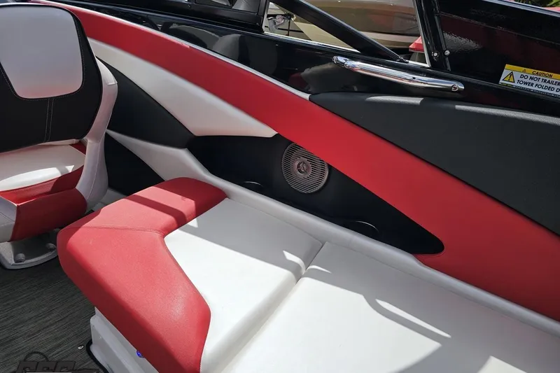 Slide: The Image of 2020 Glastron GTS 225 boat interior with red and white seating, speaker detail. - 51