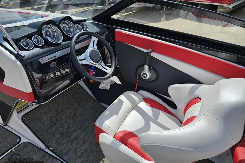 Slide: The Image of 2020 Glastron GTS 225 boat interior with red and white seating, modern dashboard, and steering wheel. - 52