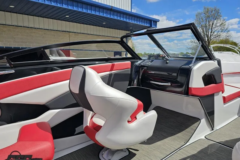 Slide: The Image of 2020 Glastron GTS 225 boat interior with red and white seating, modern dashboard. - 55