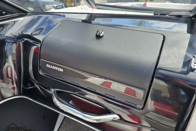 Slide: The Image of 2020 Glastron GTS 225 dashboard with glove compartment and sleek design. - 58