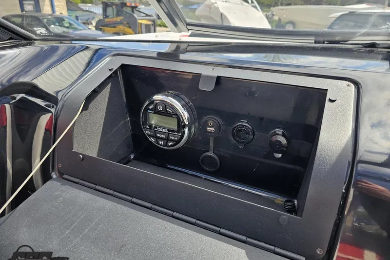 Slide: The Image of Dashboard of a 2020 Glastron GTS 225 boat with audio controls and USB port. - 59