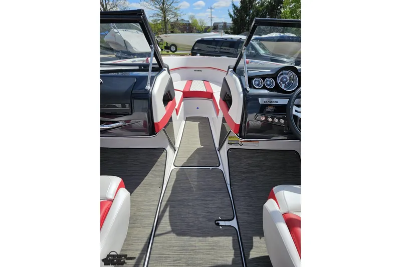 Slide: The Image of 2020 Glastron GTS 225 boat interior with red and white seating, dashboard, and steering wheel. - 60