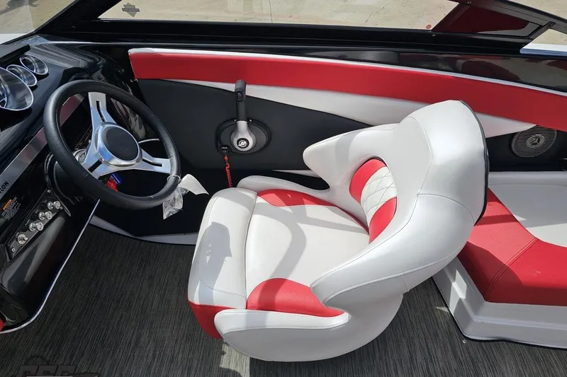Slide: The Image of 2020 Glastron GTS 225 boat interior with red and white seating and steering wheel. - 63