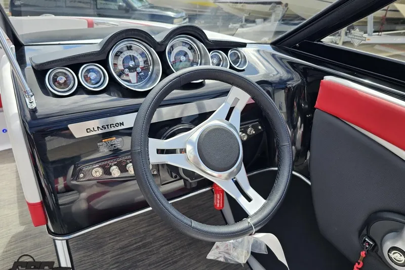 Slide: The Image of 2020 Glastron GTS 225 boat dashboard with steering wheel and gauges. - 64