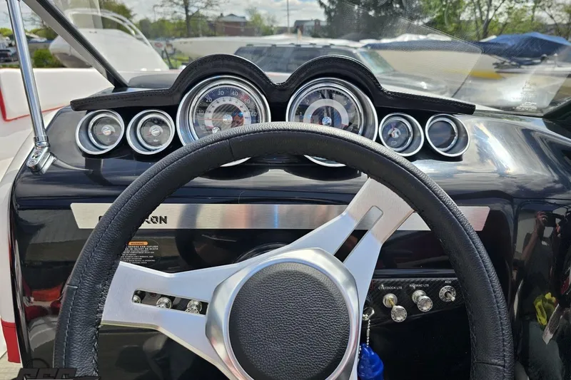Slide: The Image of Steering wheel and dashboard of 2020 Glastron GTS 225 boat with gauges. - 65
