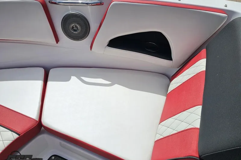 Slide: The Image of 2020 Glastron GTS 225 boat interior with red and white seating and speaker. - 75