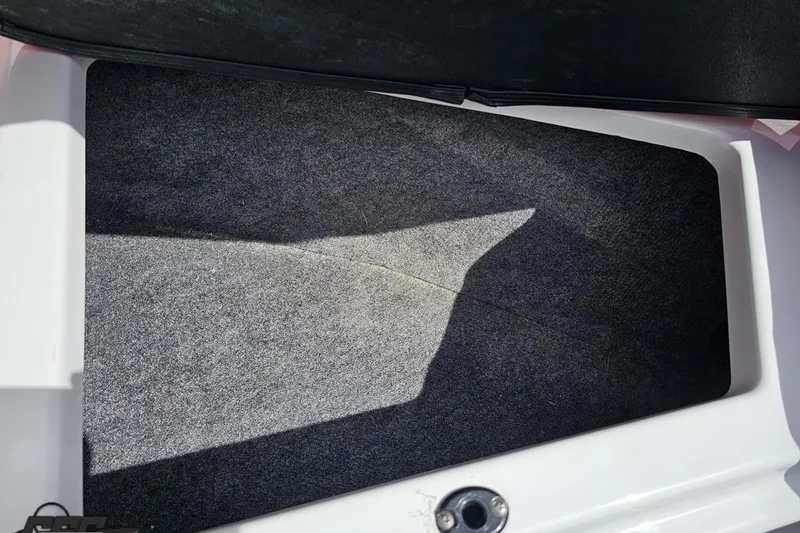 Slide: The Image of Carpeted storage compartment in a 2020 Glastron GTS 225 boat. - 82