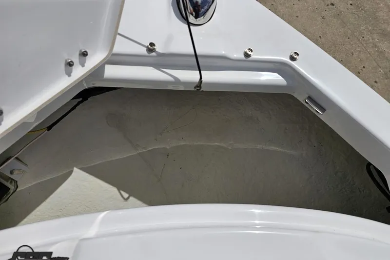 Slide: The Image of 2020 Glastron GTS 225 boat interior detail, showcasing storage compartment and hardware. - 86