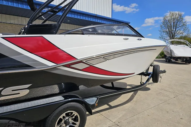 Slide: The Image of 2020 Glastron GTS 225 boat on trailer, featuring sleek red and white design. - 9