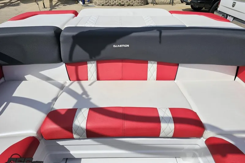 Slide: The Image of 2020 Glastron GTS 225 boat interior with red and white cushioned seating. - 92