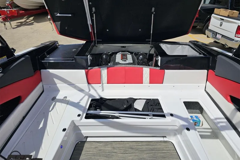 Slide: The Image of 2020 Glastron GTS 225 boat interior with open engine compartment and red accents. - 94