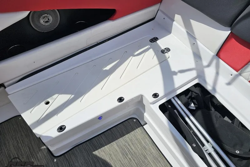 Slide: The Image of 2020 Glastron GTS 225 boat interior with red and white seating and storage compartment. - 95