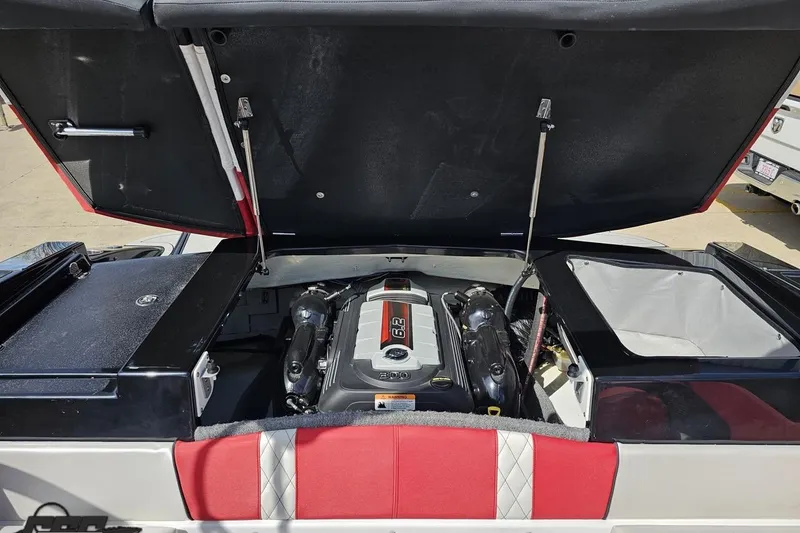 Slide: The Image of 2020 Glastron GTS 225 boat engine compartment with open hatch, showcasing powerful engine. - 97