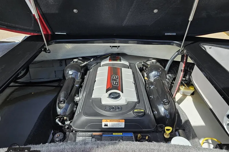 Slide: The Image of 2020 Glastron GTS 225 boat engine compartment with a 6.2L Mercury engine. - 98