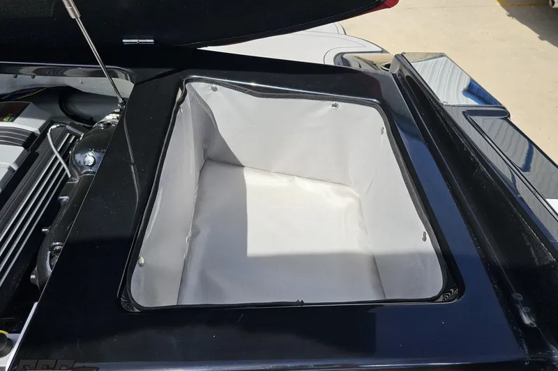Slide: The Image of Open engine compartment of 2020 Glastron GTS 225 boat, showcasing storage area. - 99