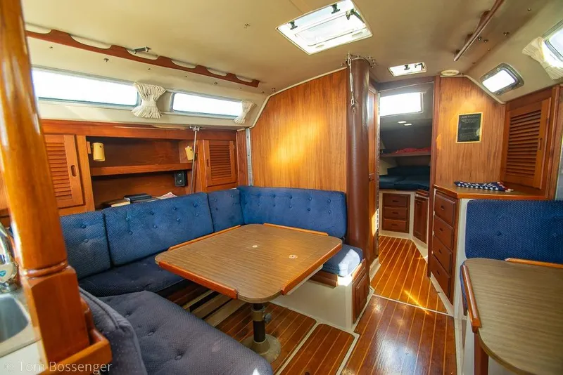 Slide: The Image of Interior of a 1987 Catalina 36 sailboat with wooden furnishings and blue upholstery. - 12