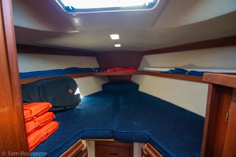 Slide: The Image of Interior cabin of a 1987 Catalina 36 sailboat with blue cushions and life jackets. - 20