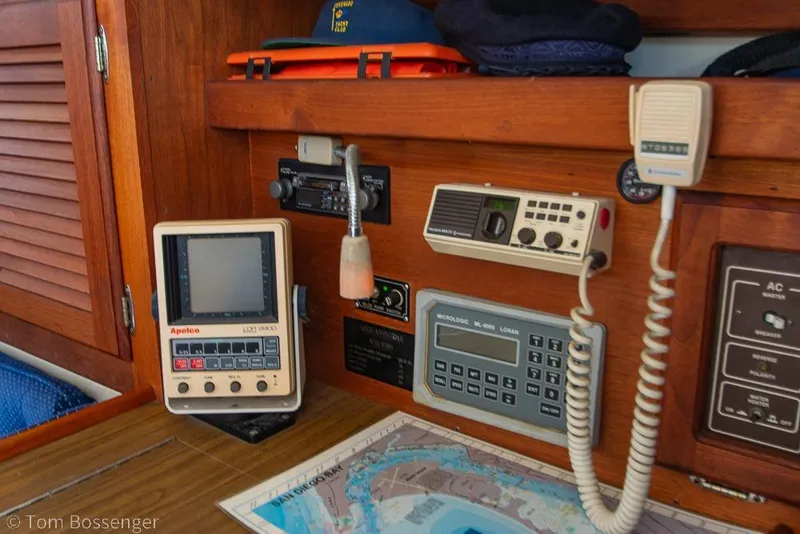 Slide: The Image of Navigation equipment on a 1987 Catalina 36 sailboat, featuring various control panels and a nautical chart. - 25