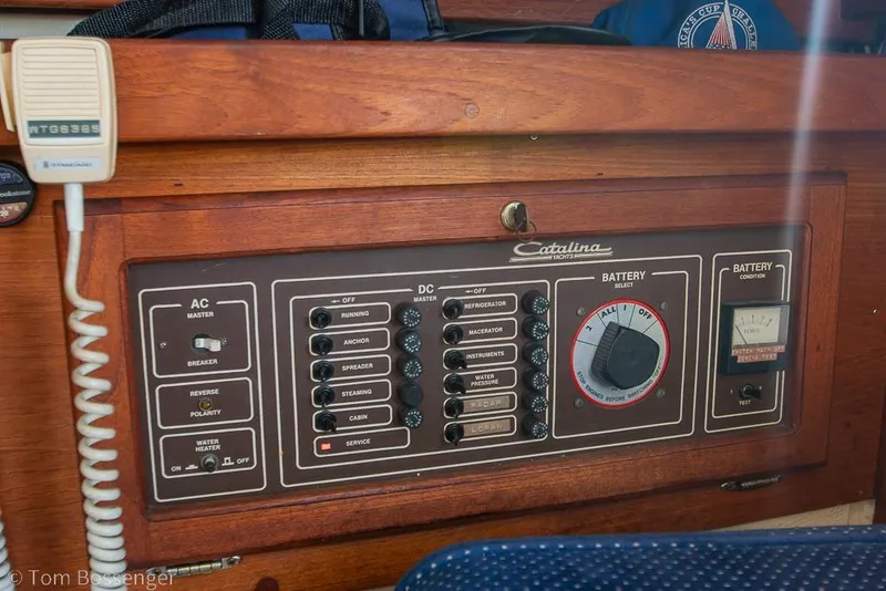 Slide: The Image of Electrical control panel of a 1987 Catalina 36 yacht, featuring AC/DC switches and battery selector. - 26