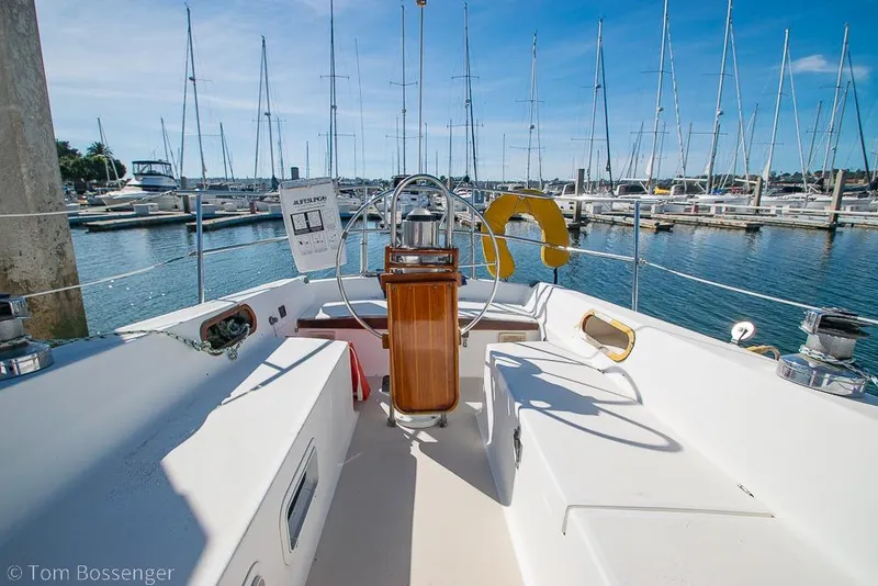 Slide: The Image of Cockpit view of 1987 Catalina 36 sailboat docked in a marina under clear skies. - 28