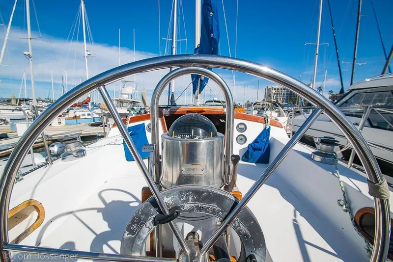Slide: The Image of Steering wheel of a 1987 Catalina 36 sailboat docked in a marina. - 30