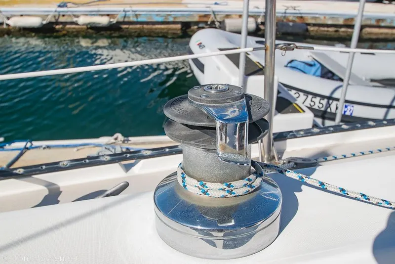 Slide: The Image of Winch on 1987 Catalina 36 sailboat deck, docked near water. - 31
