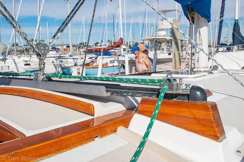 Slide: The Image of 1987 Catalina 36 sailboat docked in a marina, featuring polished wood and rigging. - 34