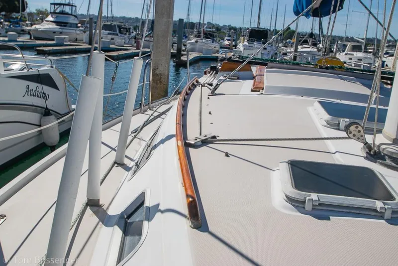 Slide: The Image of 1987 Catalina 36 sailboat docked in a marina, showcasing deck and rigging details. - 36