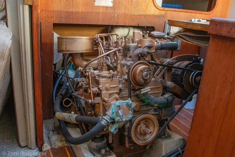 Slide: The Image of Engine compartment of a 1987 Catalina 36 sailboat, showcasing detailed mechanical components. - 39