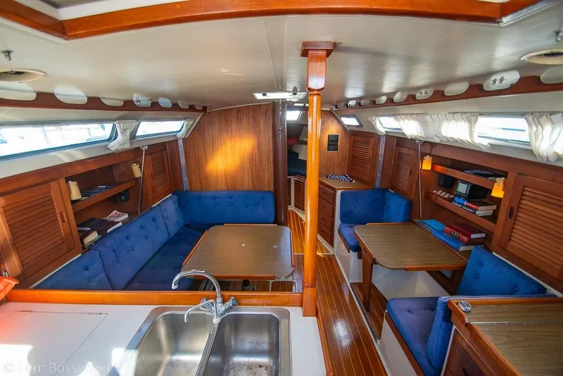 Slide: The Image of Interior of a 1987 Catalina 36 sailboat with wood finish and blue seating. - 8