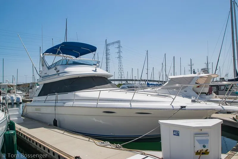 The Image of 1991 Sea Ray 370 Sedan Bridge yacht docked at marina under clear blue sky. - 1