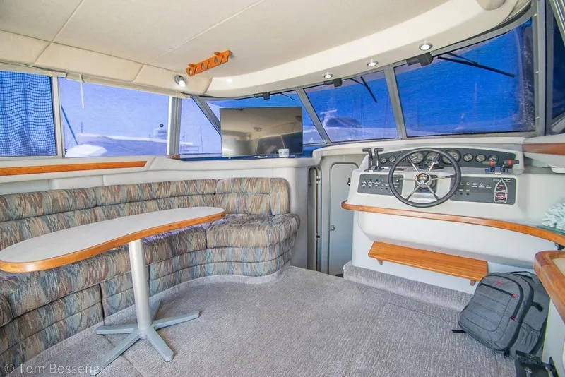 Slide: The Image of Interior of 1991 Sea Ray 370 Sedan Bridge with helm and seating area. - 10