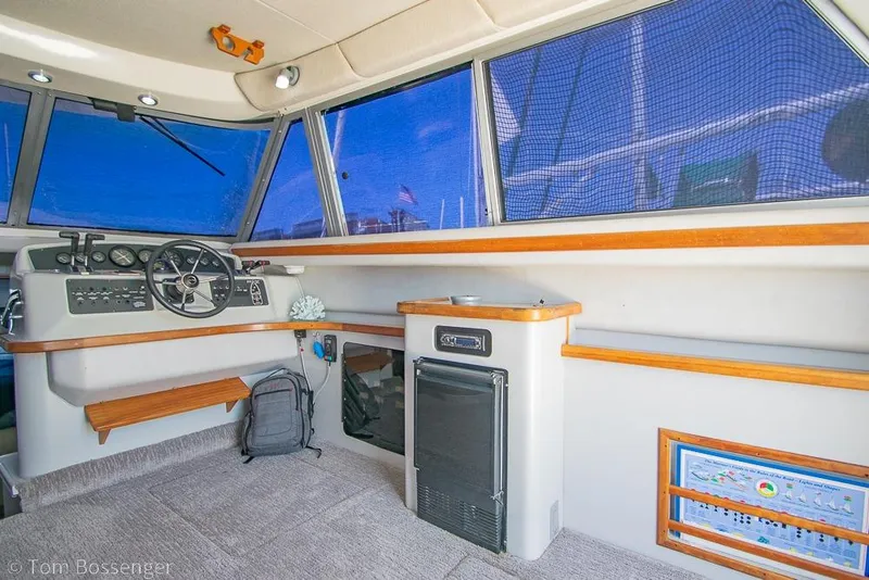 Slide: The Image of Interior of 1991 Sea Ray 370 Sedan Bridge with helm and navigation equipment. - 11