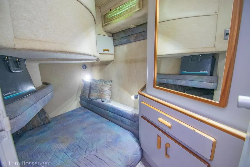 Slide: The Image of Cozy cabin interior of 1991 Sea Ray 370 Sedan Bridge with bed and storage. - 22