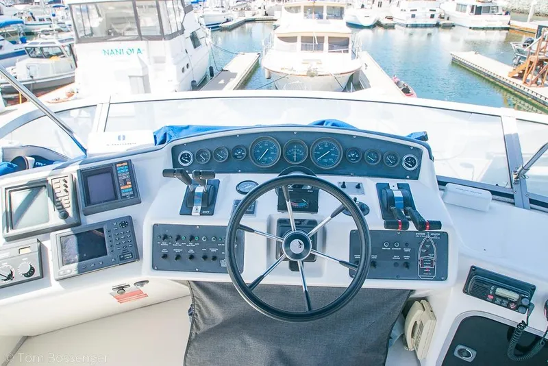 Slide: The Image of Cockpit of 1991 Sea Ray 370 Sedan Bridge with steering wheel and control panels. - 27