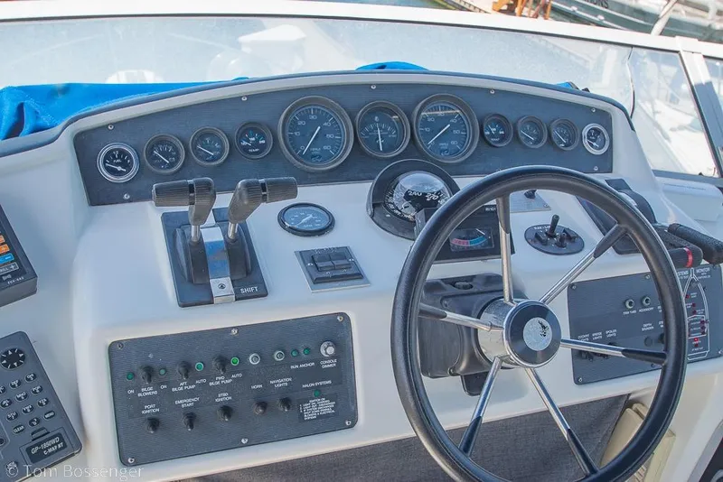 Slide: The Image of Control panel of a 1991 Sea Ray 370 Sedan Bridge boat with steering wheel and gauges. - 29