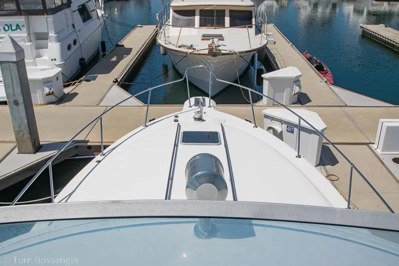 Slide: The Image of 1991 Sea Ray 370 Sedan Bridge docked at marina, view from bow. - 33