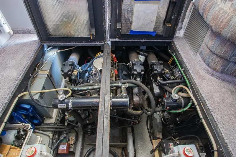 Slide: The Image of Engine compartment of a 1991 Sea Ray 370 Sedan Bridge boat, showing dual engines. - 34