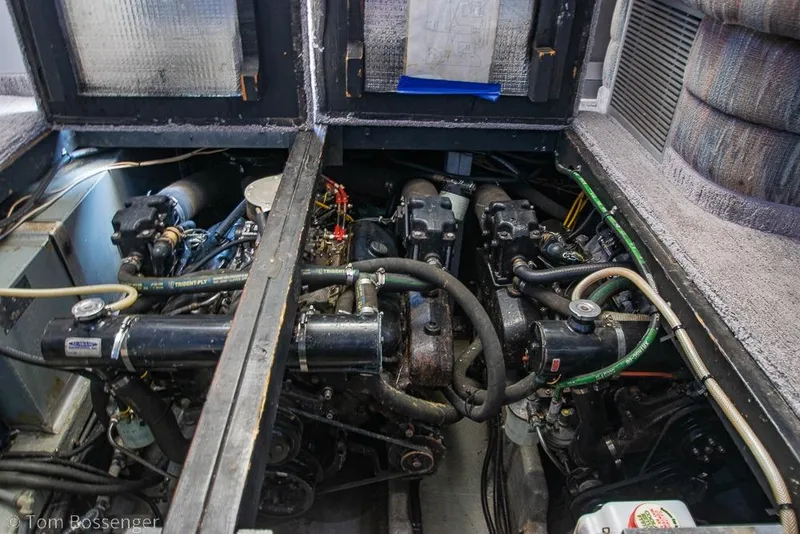 Slide: The Image of Engine compartment of a 1991 Sea Ray 370 Sedan Bridge, showcasing dual engines and mechanical components. - 35